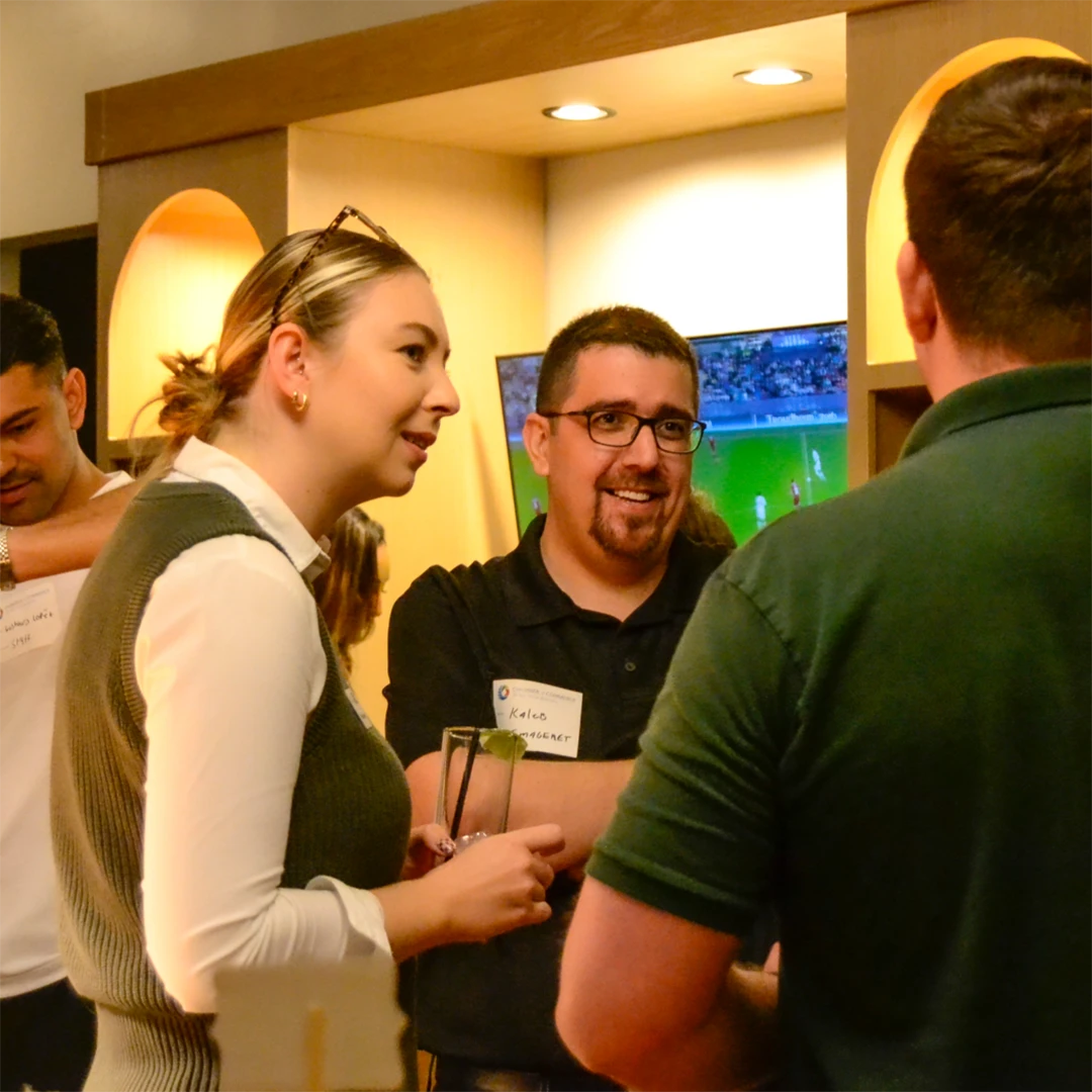 Several individuals gathered in a circle, chatting and enjoying each other's company.